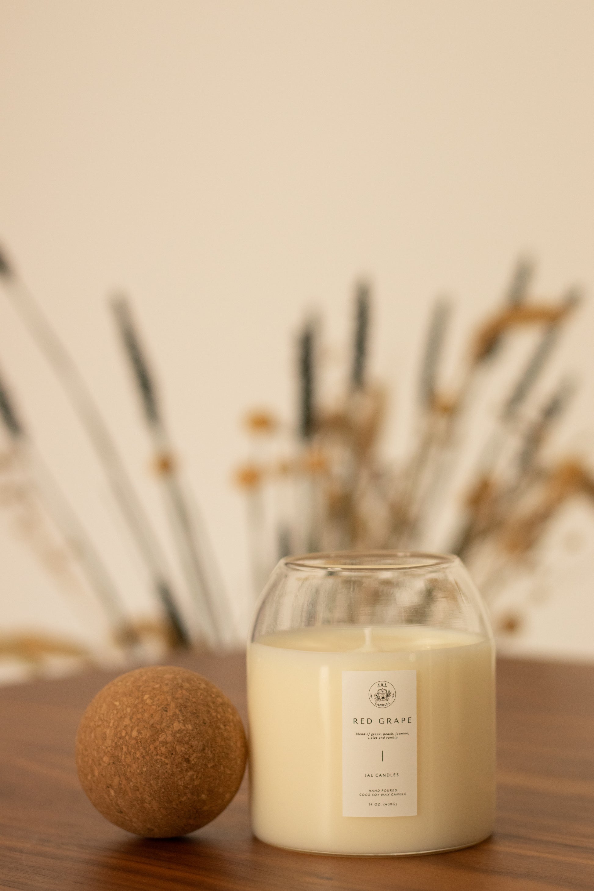 Red Grape scented candle by JAL Candles, 400g, coconut soy wax, on table with cozy background, Cyprus