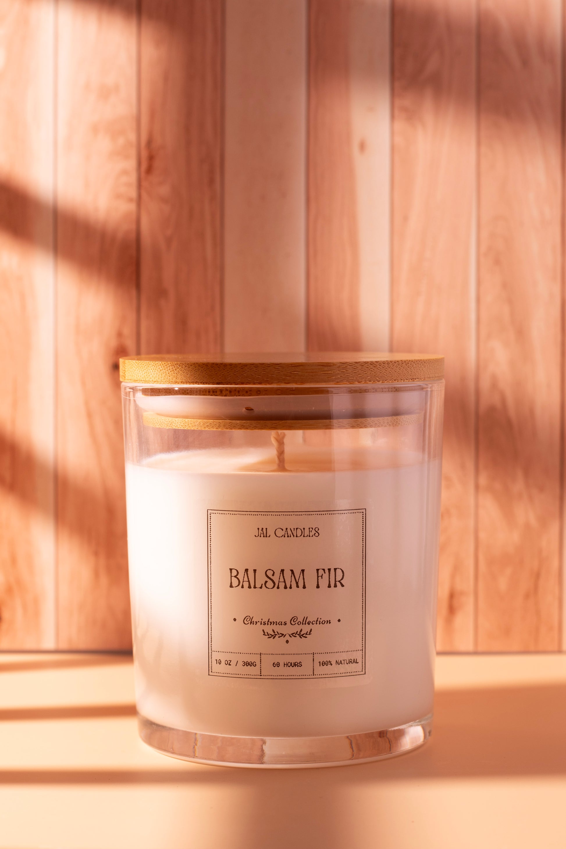 Hand-poured Balsam Fir Christmas candle by JAL Candles, crafted from coconut-soy wax with a wooden lid, photographed in warm festive light, handmade in Cyprus.