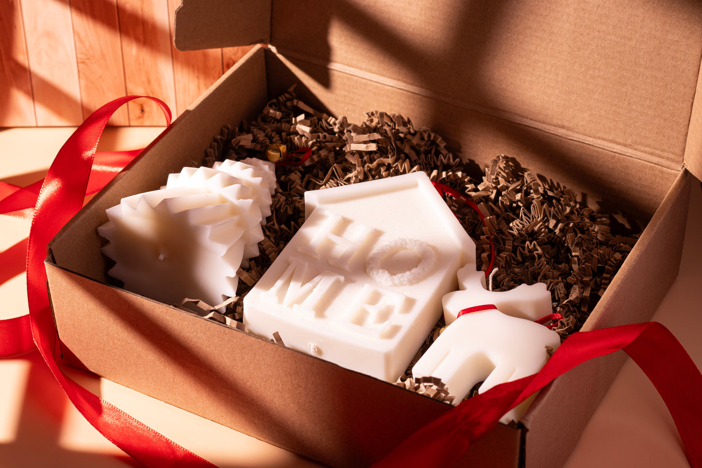 JAL Candles Christmas Collection featuring festive hand-poured candles and gift boxes, photographed with warm holiday decor in Cyprus.