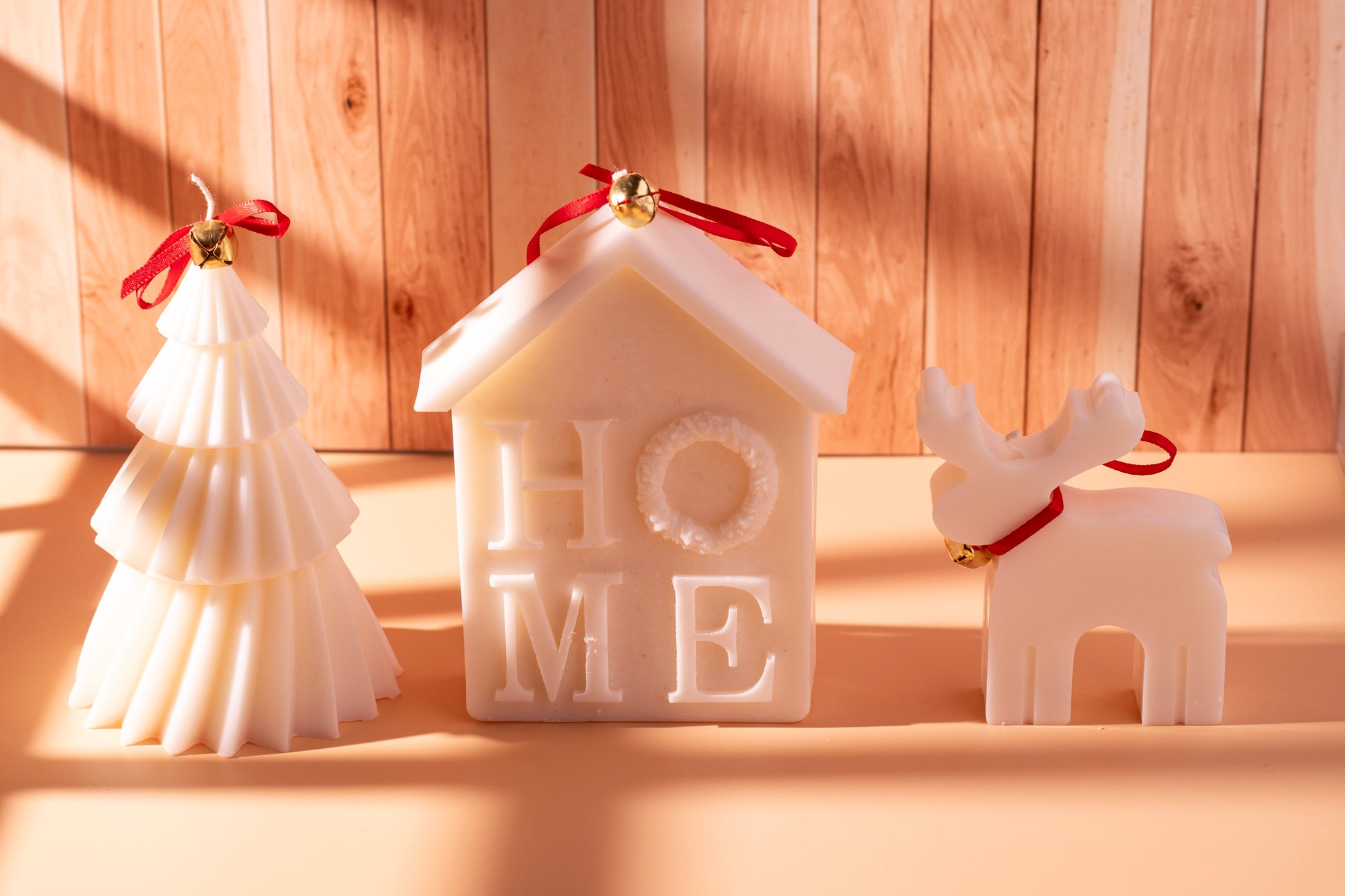 Christmas soy candles and gift sets by JAL Candles, beautifully arranged with ribbons and red berries, handmade in Cyprus.