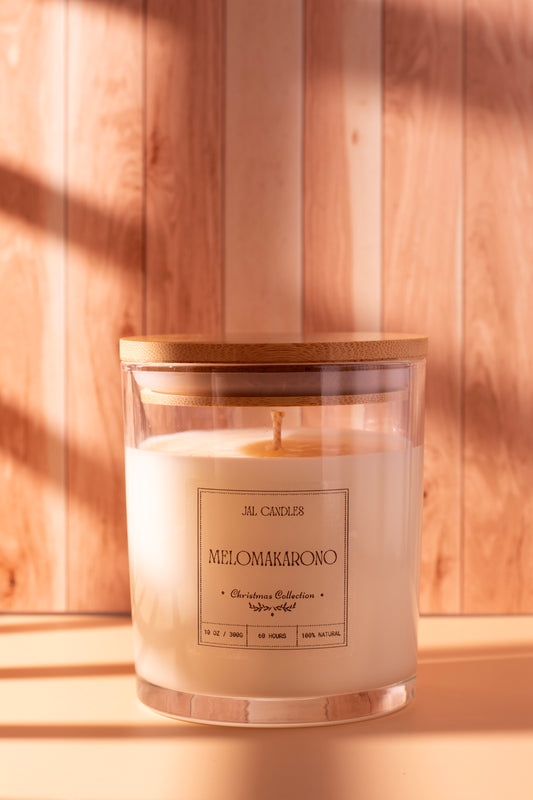 Handcrafted Melomakarono Christmas candle by JAL Candles, inspired by the traditional Greek holiday dessert, made from coconut-soy wax and photographed in cozy festive light in Cyprus.
