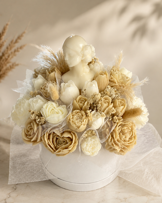 Cream wax flower bouquet with central female bust candle in white round gift box
