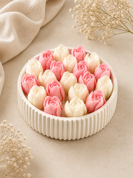 Fluted cream tray filled with pink and white rosebud wax candles