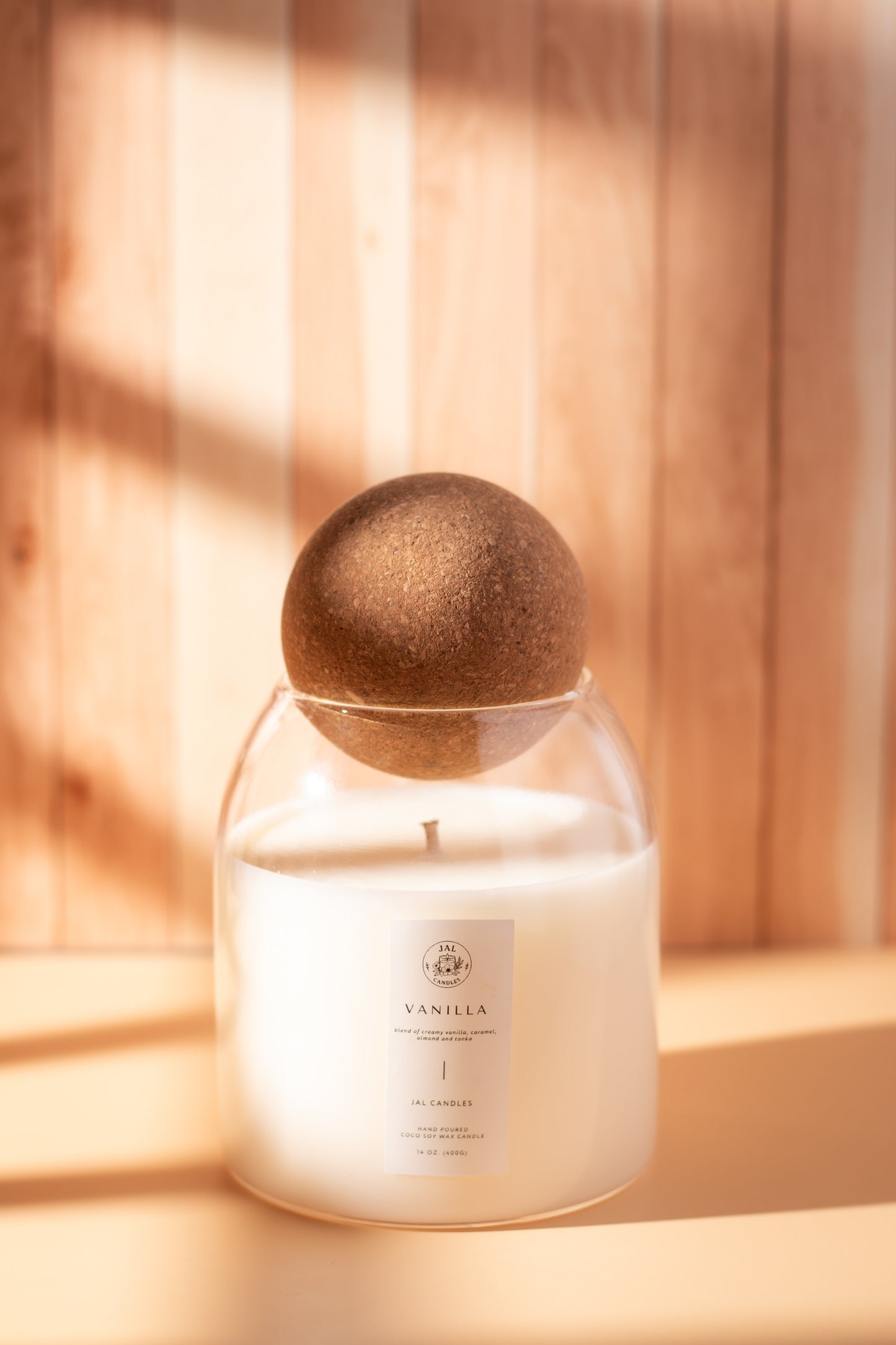 Hand-poured vanilla candle with wooden lid by JAL Candles, photographed in warm natural light on a wooden background, made in Cyprus.