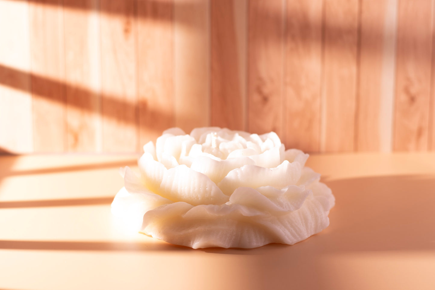 Side view of white peony-shaped sculpted soy candle by JAL Candles, handmade in Cyprus and captured in natural light.