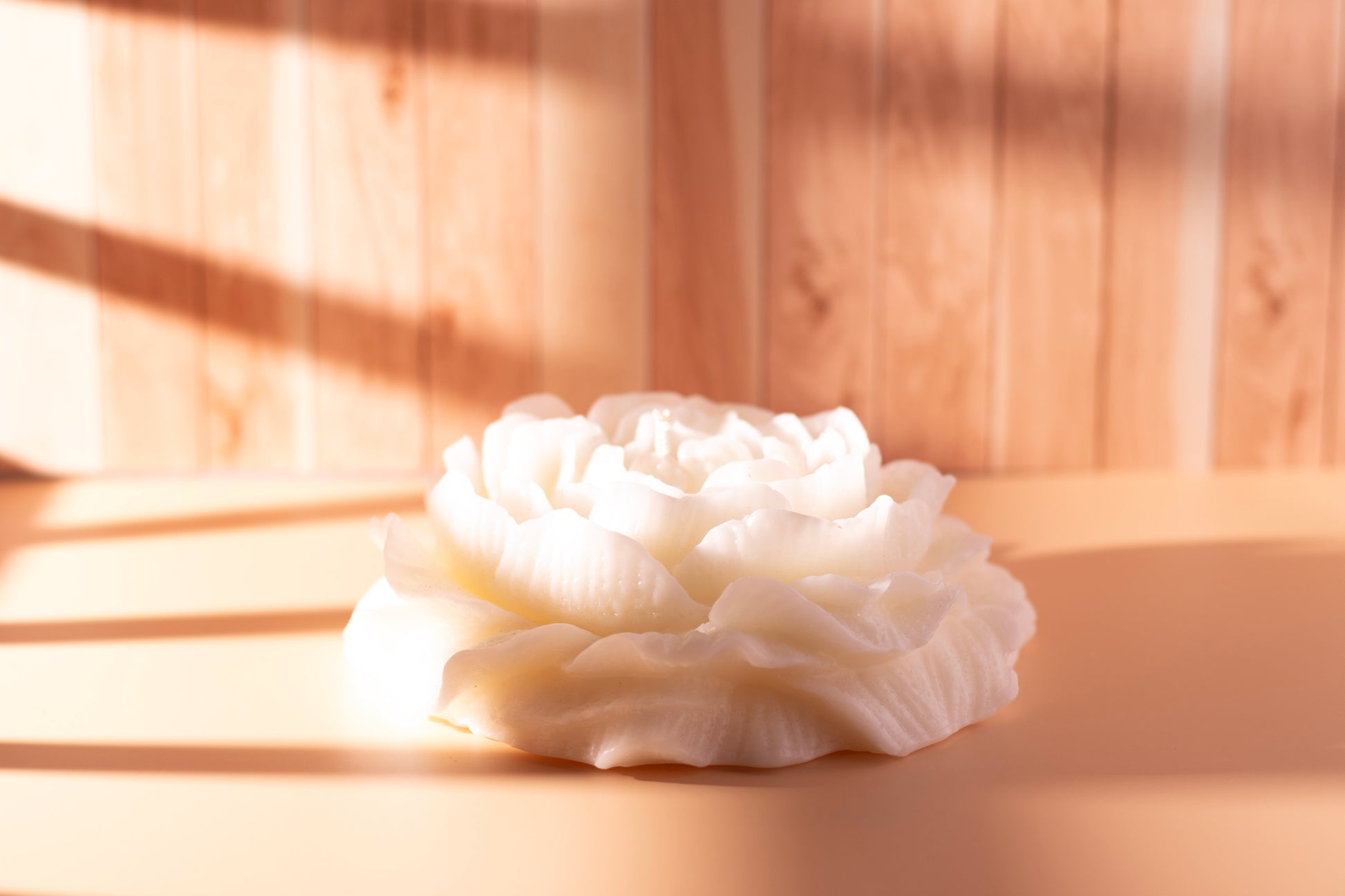 Side view of white peony-shaped sculpted soy candle by JAL Candles, handmade in Cyprus and captured in natural light.