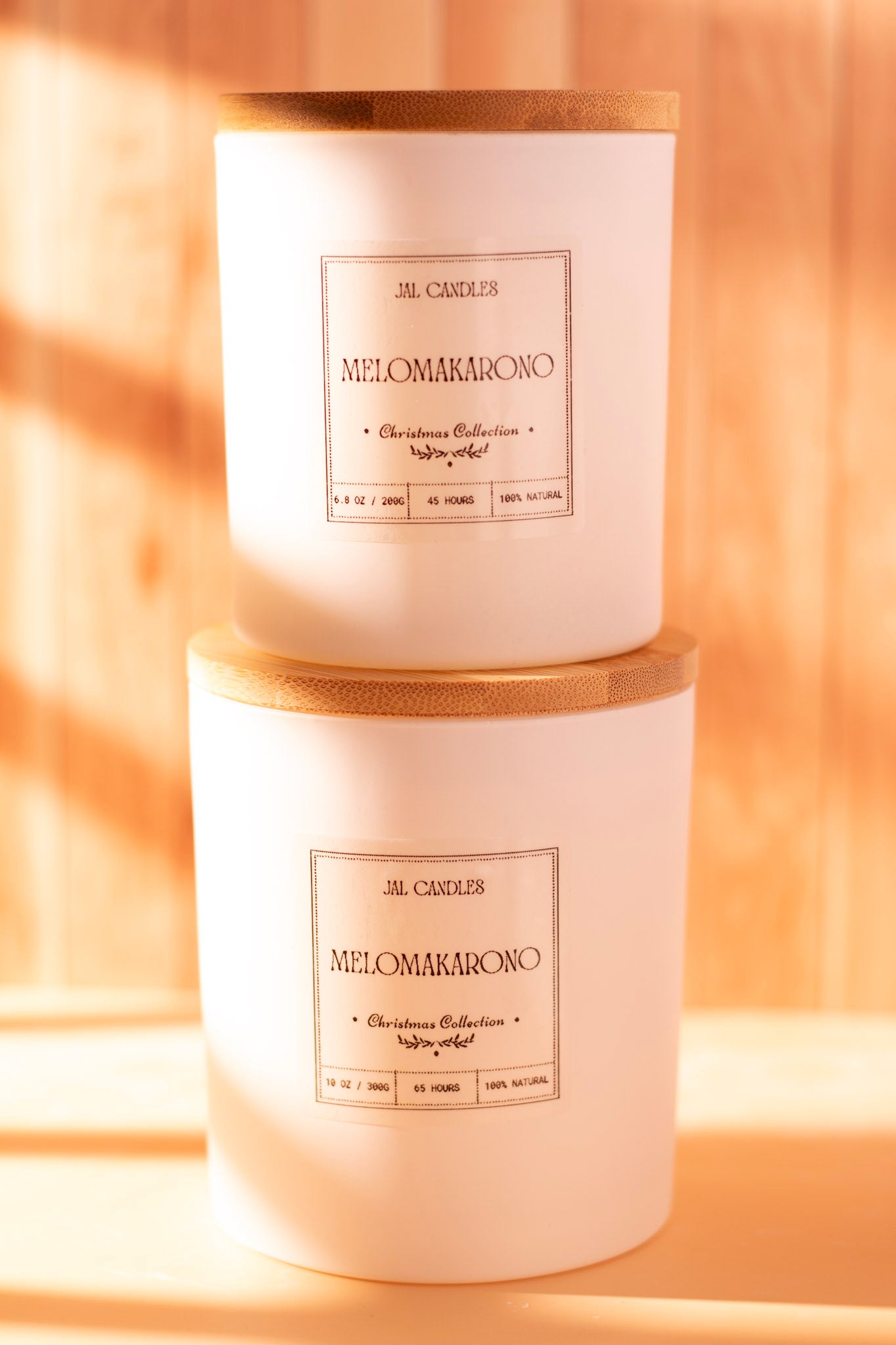 Two stacked Melomakarono handmade candles in ceramic jars